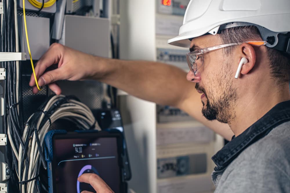 Electrical technician standing with equipment for service planning